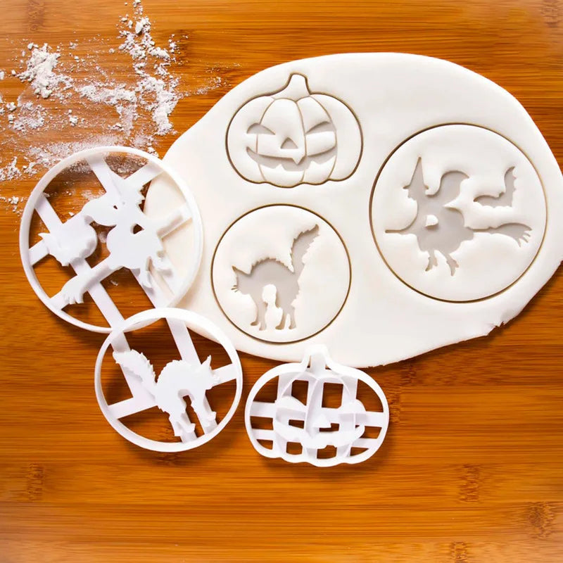 A set of white 3D Halloween cookie cutters and fondant stamps shaped like pumpkins, ghosts, and bats on a wooden surface.