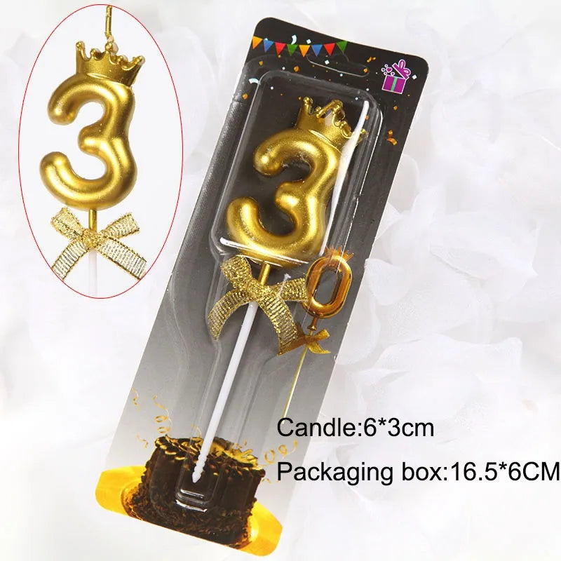A gold crown number candle shaped like the number 3 is displayed in a packaging box for birthdays and celebrations.