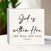 A white wooden desktop ornament featuring the Bible verse God is within Her from Psalm 46:5