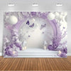A dreamy purple butterfly photo backdrop featuring white spherical lights and floral arrangements for events.