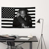 A black and white striped flag tapestry banner featuring a person's face against the background.