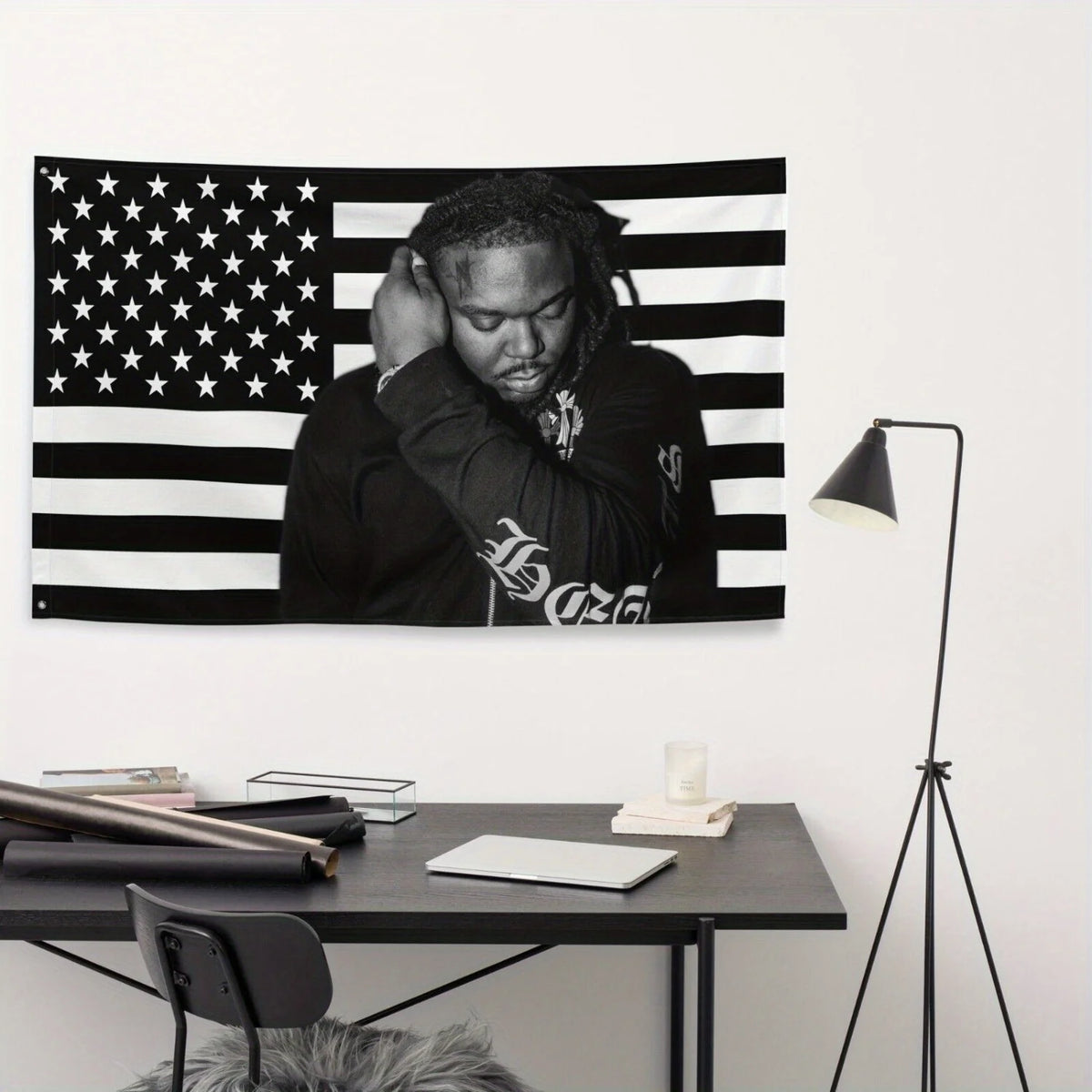 A black and white striped flag tapestry banner featuring a person's face against the background.