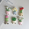 A set of five kawaii potted plant fridge magnets featuring various green and pink plants in small ceramic pots.