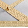 Gold self-adhesive PVC corner trim with 3D textured edge shown in an X-shape pattern