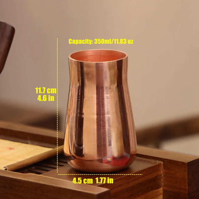 A handcrafted pure copper vintage mug with a capacity of 350ml resting on a wooden surface.