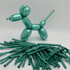 A green glossy latex modeling balloon shaped like a dog, with a bundle of similar balloons below it.
