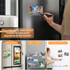 A hand uses a permanent marker to add a signature to the border of a magnetic picture frame on a refrigerator.