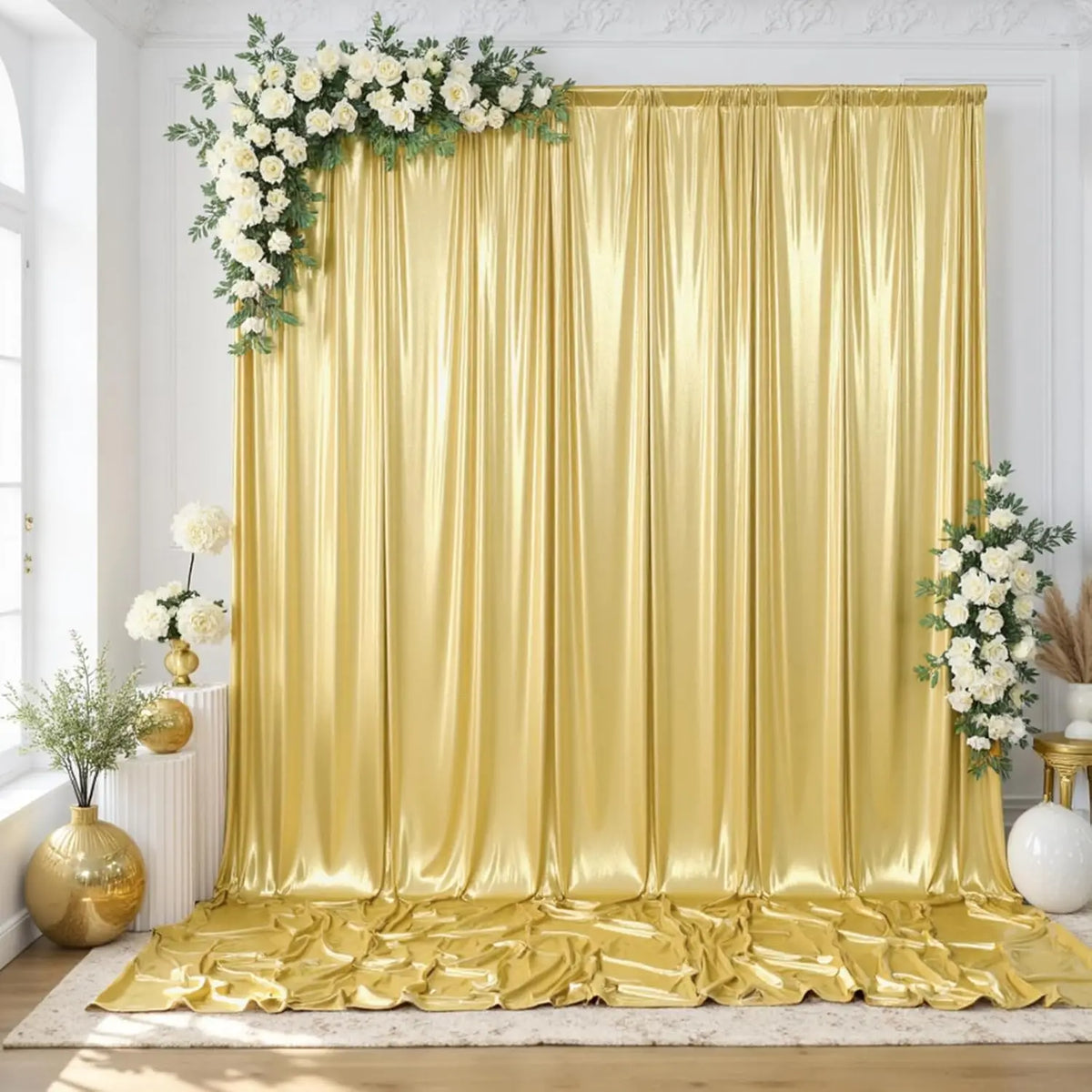 A luxurious gold sequin backdrop curtain draped in flowing fabric for photography and events.