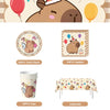 A kit for a happy capybara birthday party featuring plates, napkins, cups, and a tablecloth.