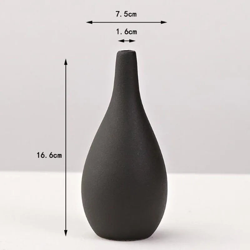 A matte black ceramic vase with a tapered neck and rounded body, shown against a white background.
