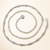 A set of three silver crystal waist chains arranged in concentric circles.