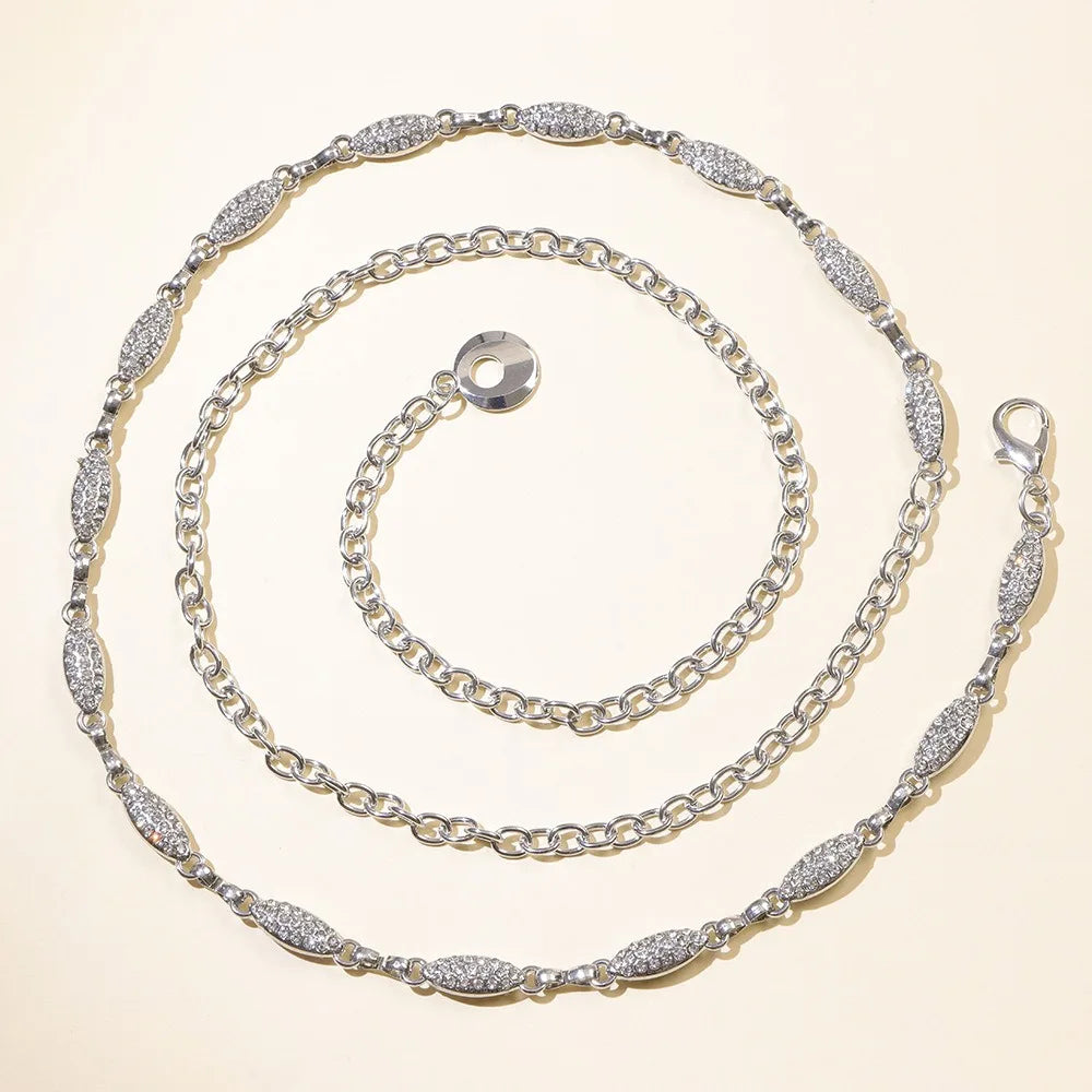 A set of three silver crystal waist chains arranged in concentric circles.