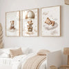 A set of three framed canvas art prints featuring teddy bears in clouds and an aerial theme for a nursery