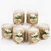 A set of five natural wooden candle holders wrapped in twine with heart-shaped thank you messages