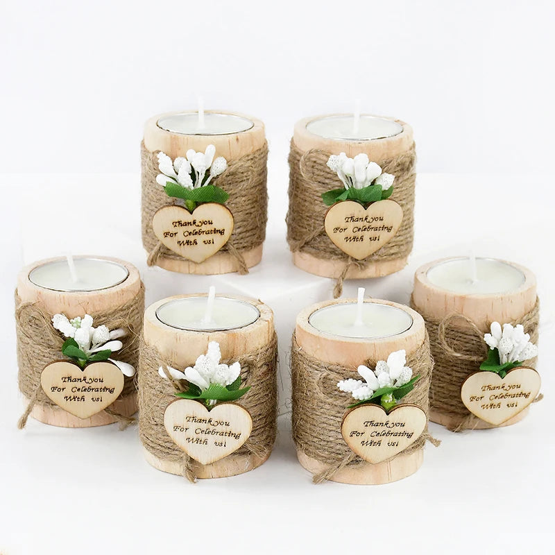 A set of five natural wooden candle holders wrapped in twine with heart-shaped thank you messages