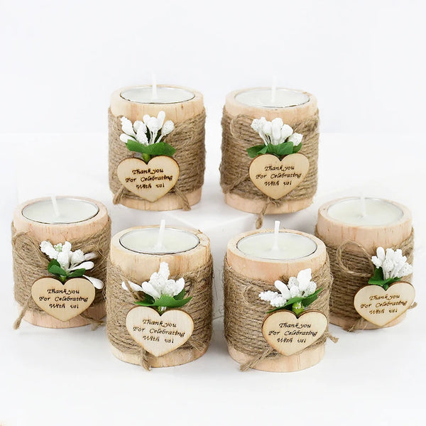 A set of five natural wooden candle holders wrapped in twine with heart-shaped thank you messages