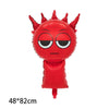 A red balloon shaped like a horned monster face with black eyes and a body, used for a party decoration.
