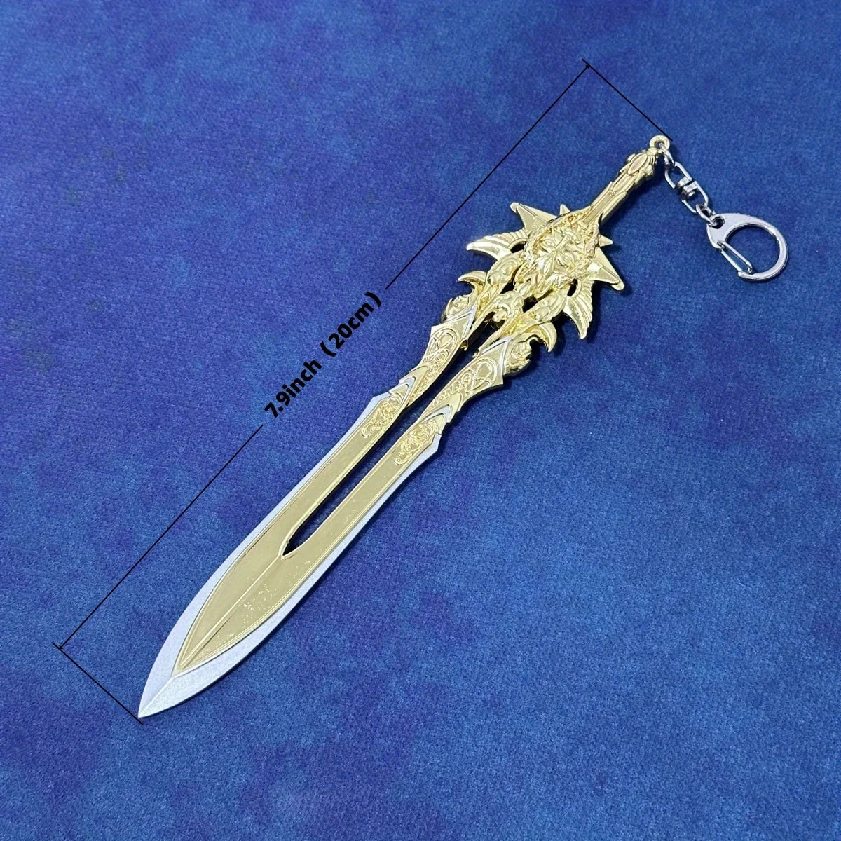 A detailed miniature collectible sword resembling a Katana with an ornate hilt and a gold-colored blade, shown against a blue