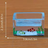 A clear acrylic block featuring colorful fish and aquatic plants for a decorative display.