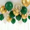 A collection of chrome gold and dark green balloons tied together on white string