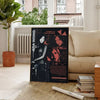 A dark poster featuring characters from Resident Evil, displayed in a bright interior setting.