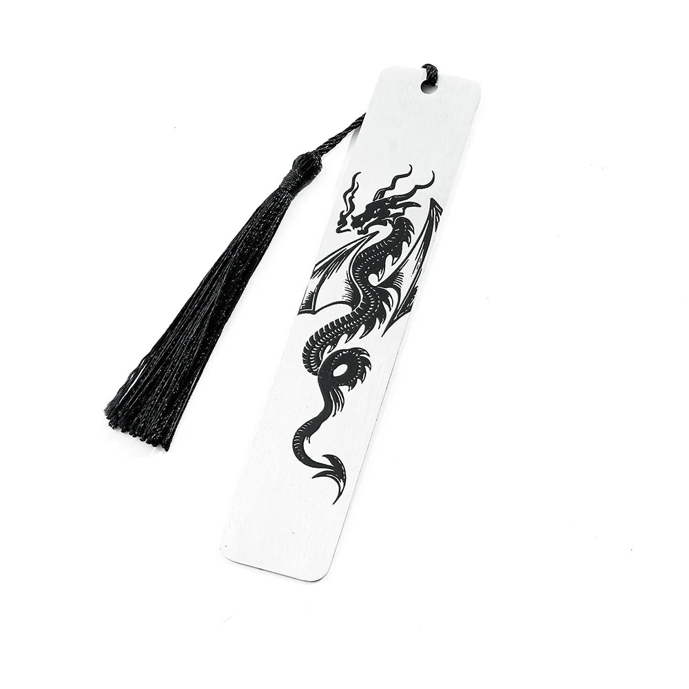 A white bookmark with a black dragon design and a black tassel.