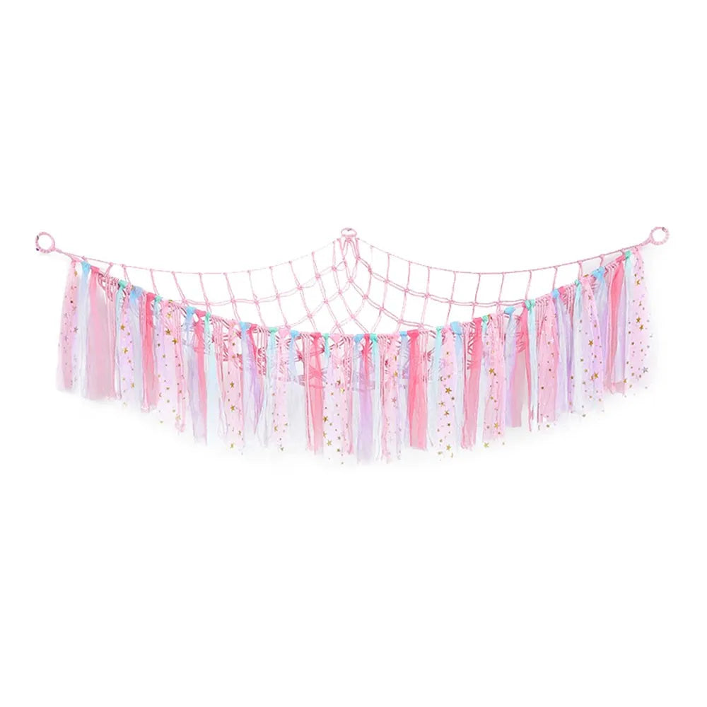 A colorful multi-use storage hammock for toys and plushies made of pink, blue, and purple fabric streamers.