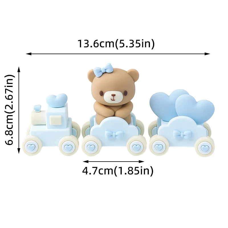 Light blue baby blocks cake toppers featuring a bear and a car design.