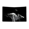 Black and white photograph of Michael Jackson in silhouette, wearing a flowing garment.