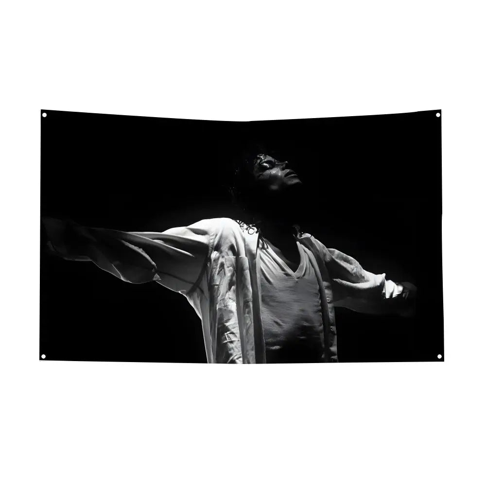 Black and white photograph of Michael Jackson in silhouette, wearing a flowing garment.