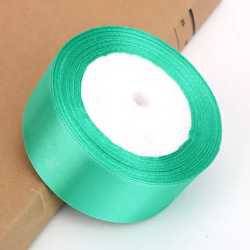 Roll of bright green satin ribbon for crafts and gift wrapping
