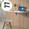 A set of two black heavy-duty foldable wall-mounted shelf brackets is shown next to a laptop on a wooden desk.