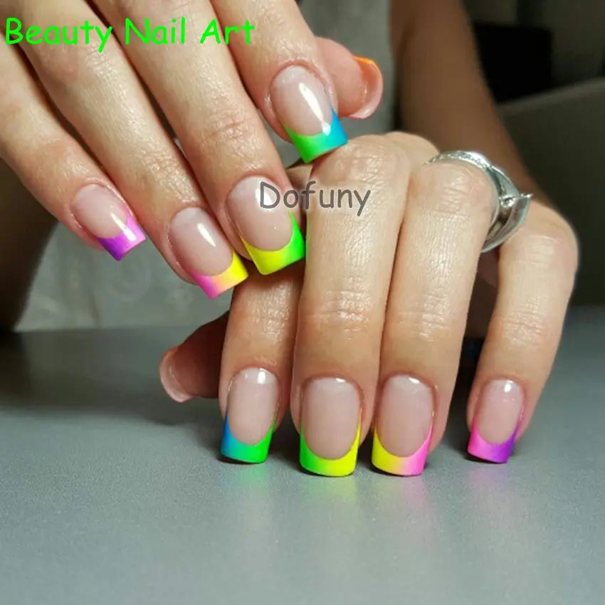 A hand displays a set of neon fluorescent pigment powders used for nail art, featuring various bright colors on fingernails.