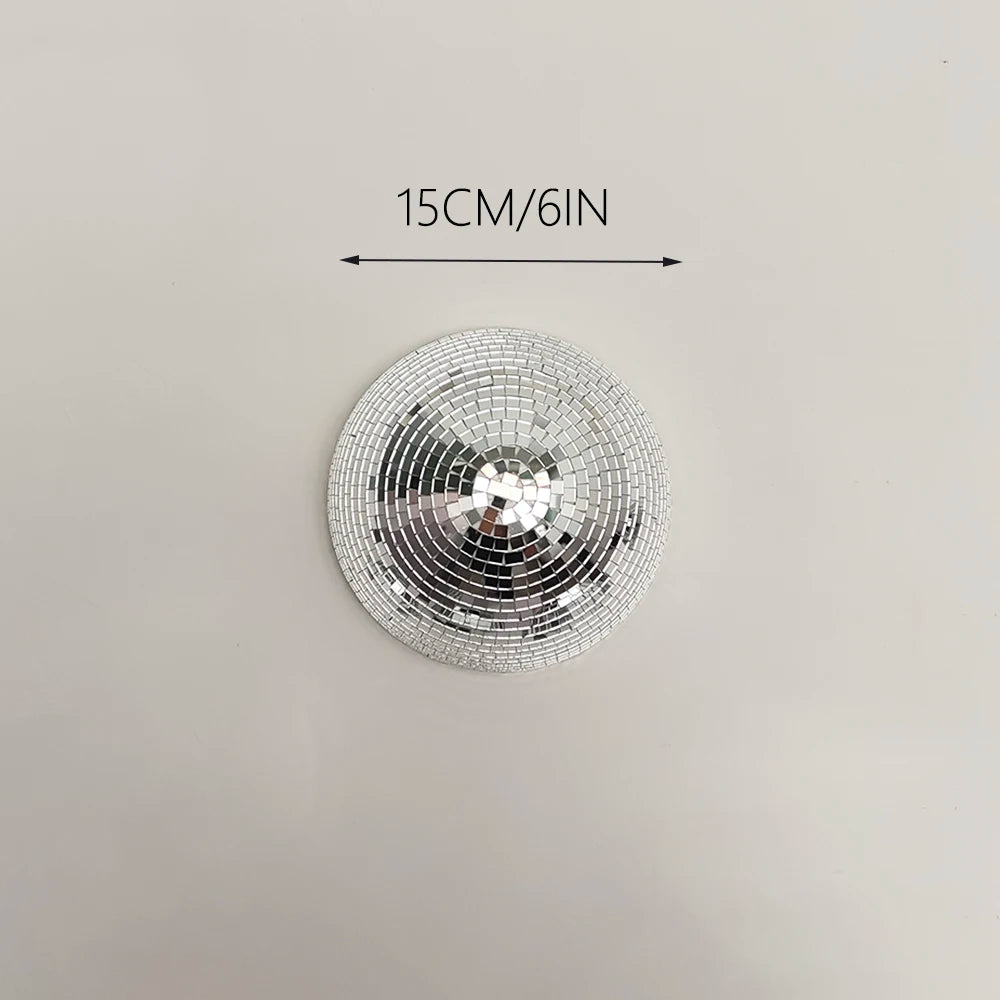 Silver disco ball decor with a 15cm diameter, mounted on a wall.