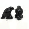 Hand-carved black obsidian raven figurine shown from the side and back with dimensions.
