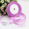 Roll of pink silk satin ribbon used for crafting or decoration