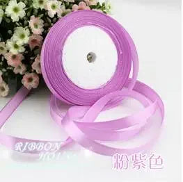 Roll of pink silk satin ribbon used for crafting or decoration