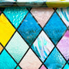 Rainbow stained glass window film featuring various iridescent and vibrant colors in a diamond pattern.
