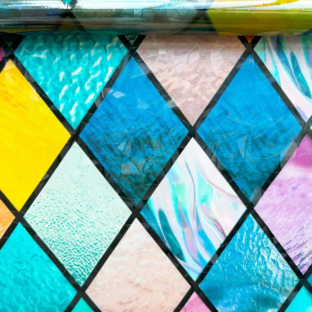 Rainbow stained glass window film featuring various iridescent and vibrant colors in a diamond pattern.