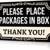 A black rectangular sign with cream text instructing to place packages in a box and thanking the recipient.