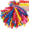 A large bundle of 100 colorful spiral latex party balloons in various bright colors is shown being blown up.