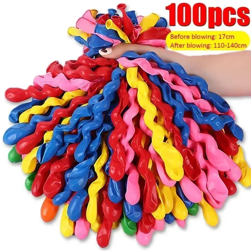A large bundle of 100 colorful spiral latex party balloons in various bright colors is shown being blown up.