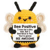 A yellow crochet bee plush toy with black antennae and fuzzy wings.