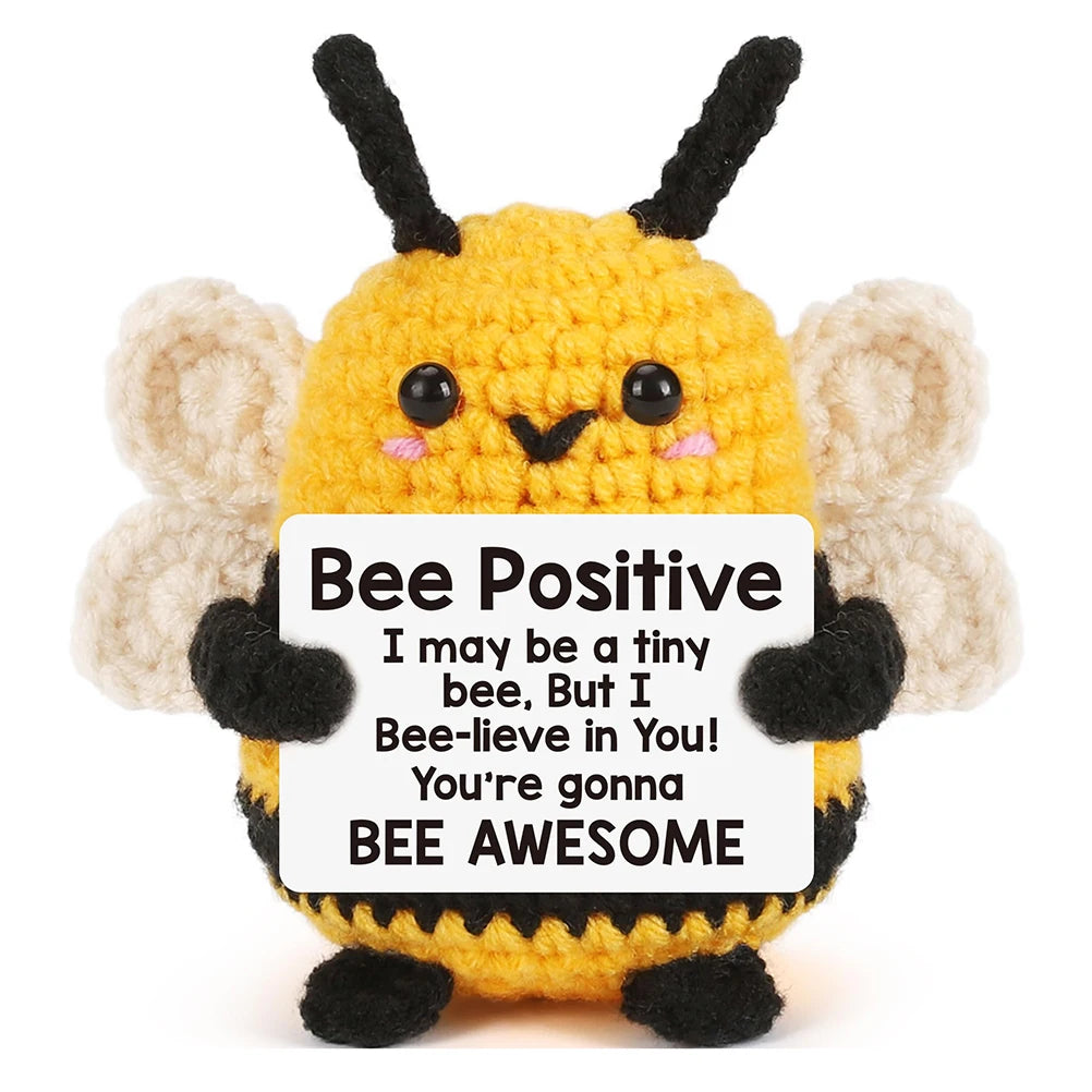 A yellow crochet bee plush toy with black antennae and fuzzy wings.