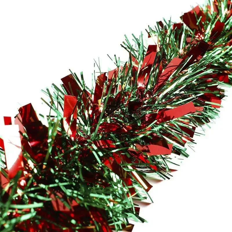 A close-up of a festive Christmas tinsel garland made of shiny red and green metallic strips.