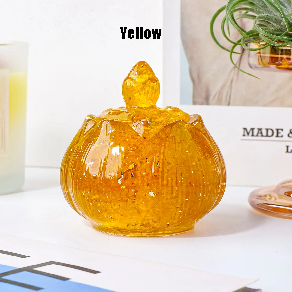 A smooth, amber-colored crystal bowl with a pointed top sits on a white surface.