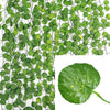 Green artificial ivy vine garland covering a black mesh background for home decor