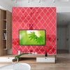A modern living room featuring a red diamond patterned wall and a large flat-screen television.