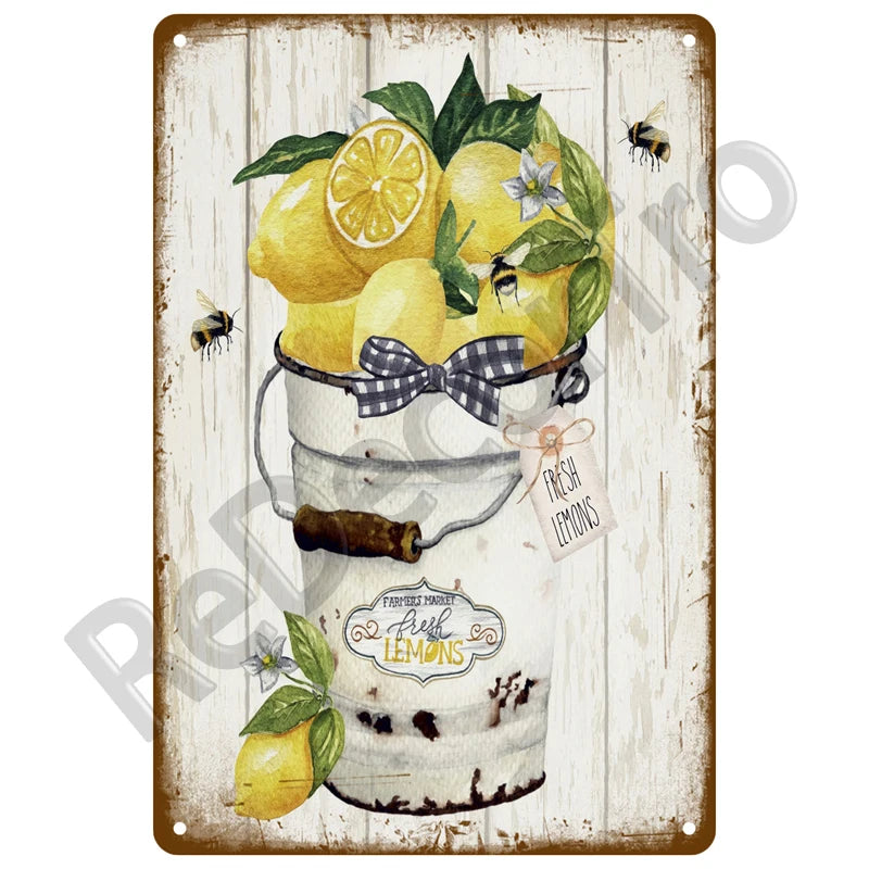 A vintage metal tin sign featuring fresh lemons and a lemon cake.