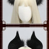 A pair of black bat-eared headwear with purple accents worn on a blonde wig display.